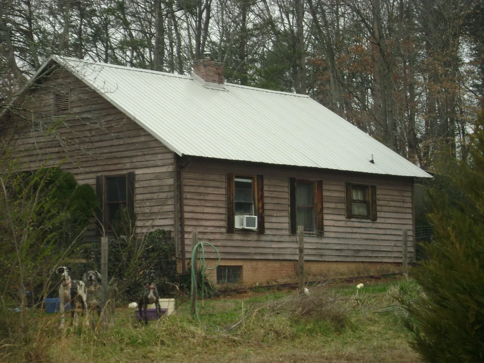 White metal roof on an old wood sided farmhouse, from a Metal Roof Installation job in Sumter