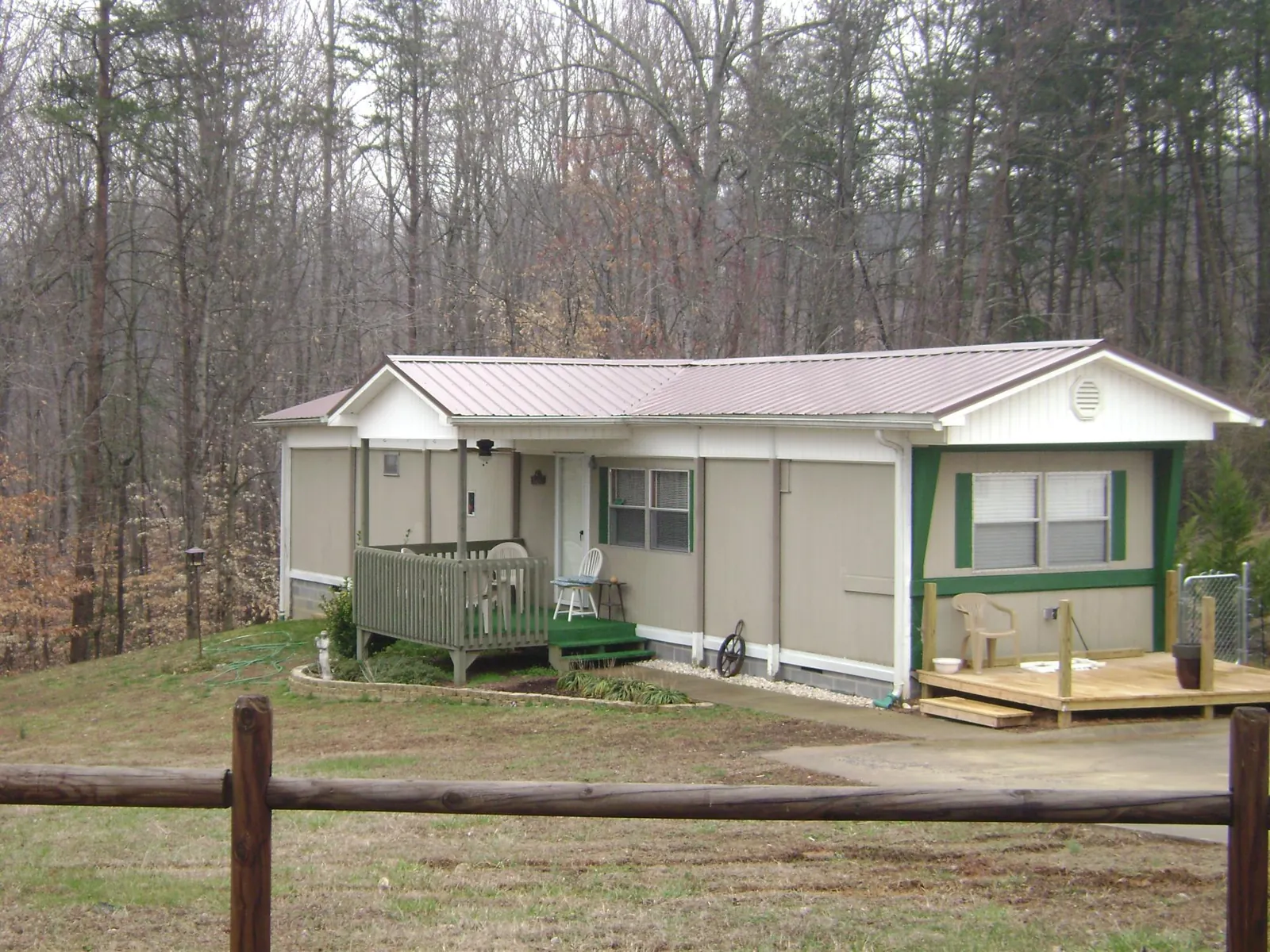 Mauve metal roof on a manufactured home with a new front deck in Sumter